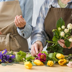 Two people making flower bouquets